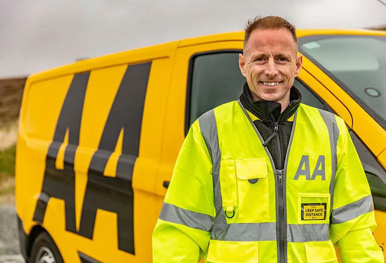 aa worker smiling in front of van