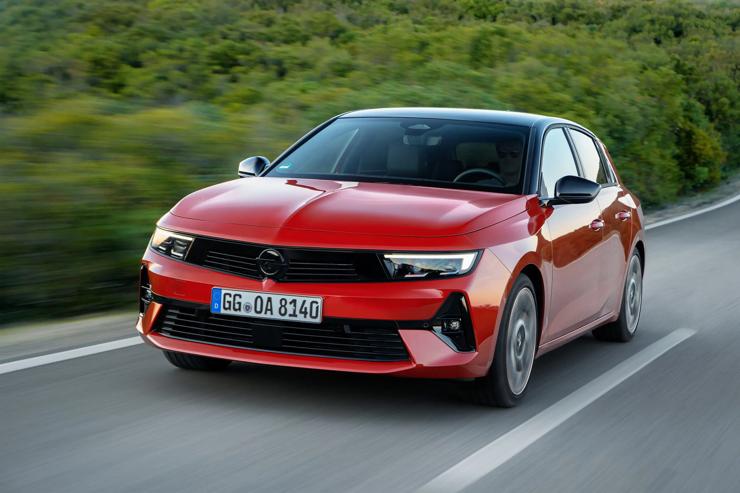 A red Opel Astra driving