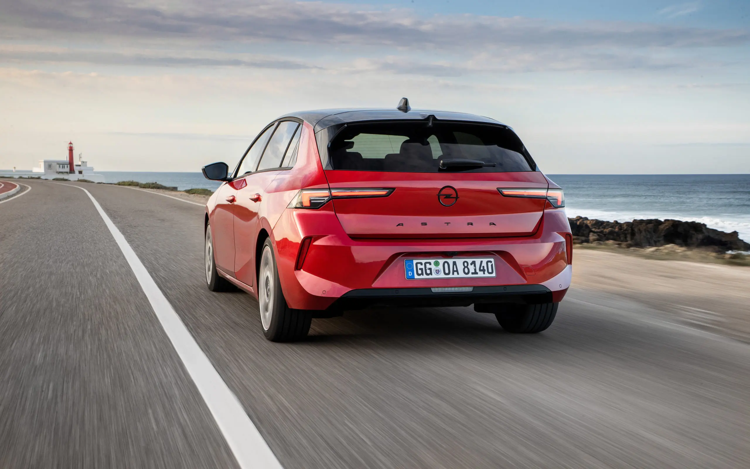 A red Opel Astra driving