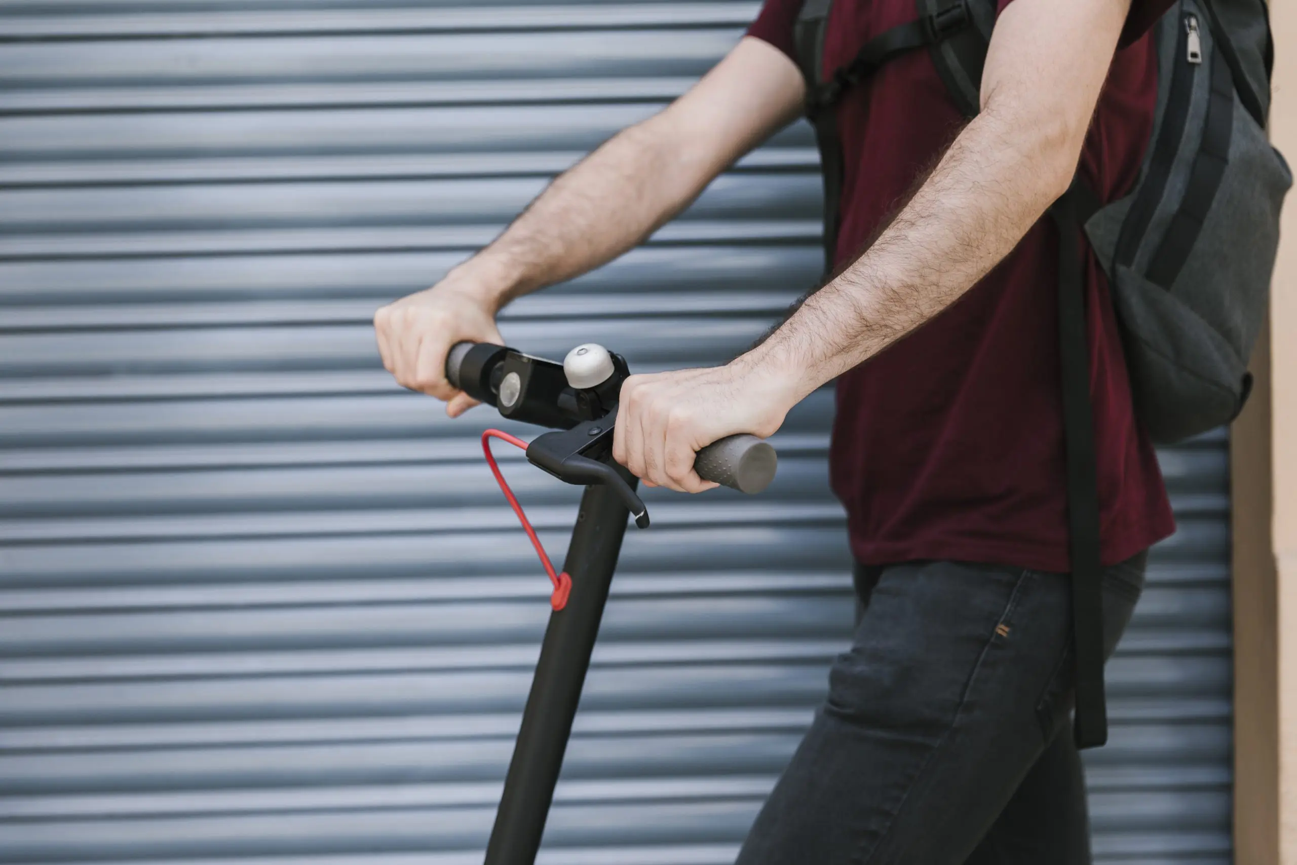 Person riding an e-scooter in an urban setting.