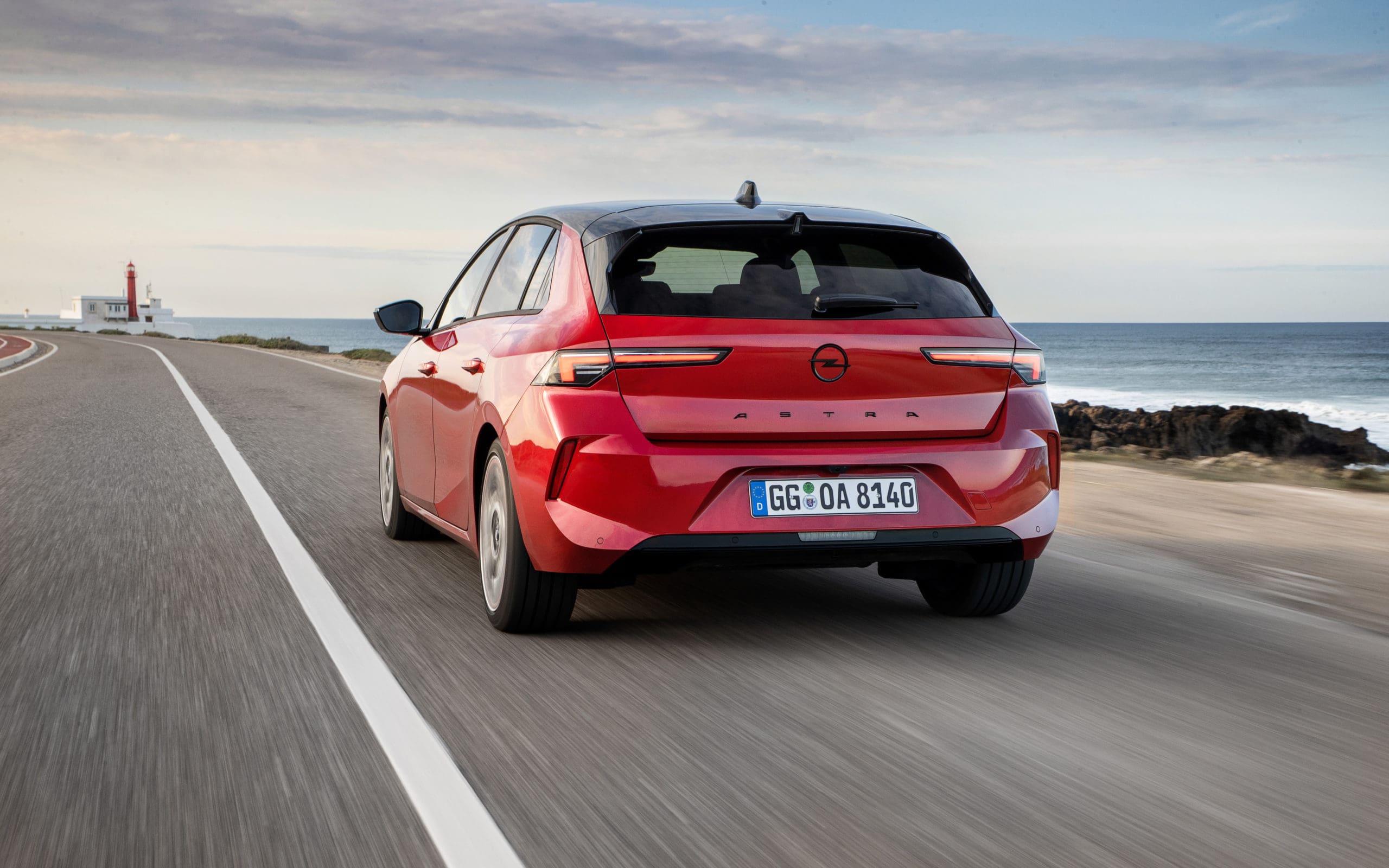 A red Opel Astra driving