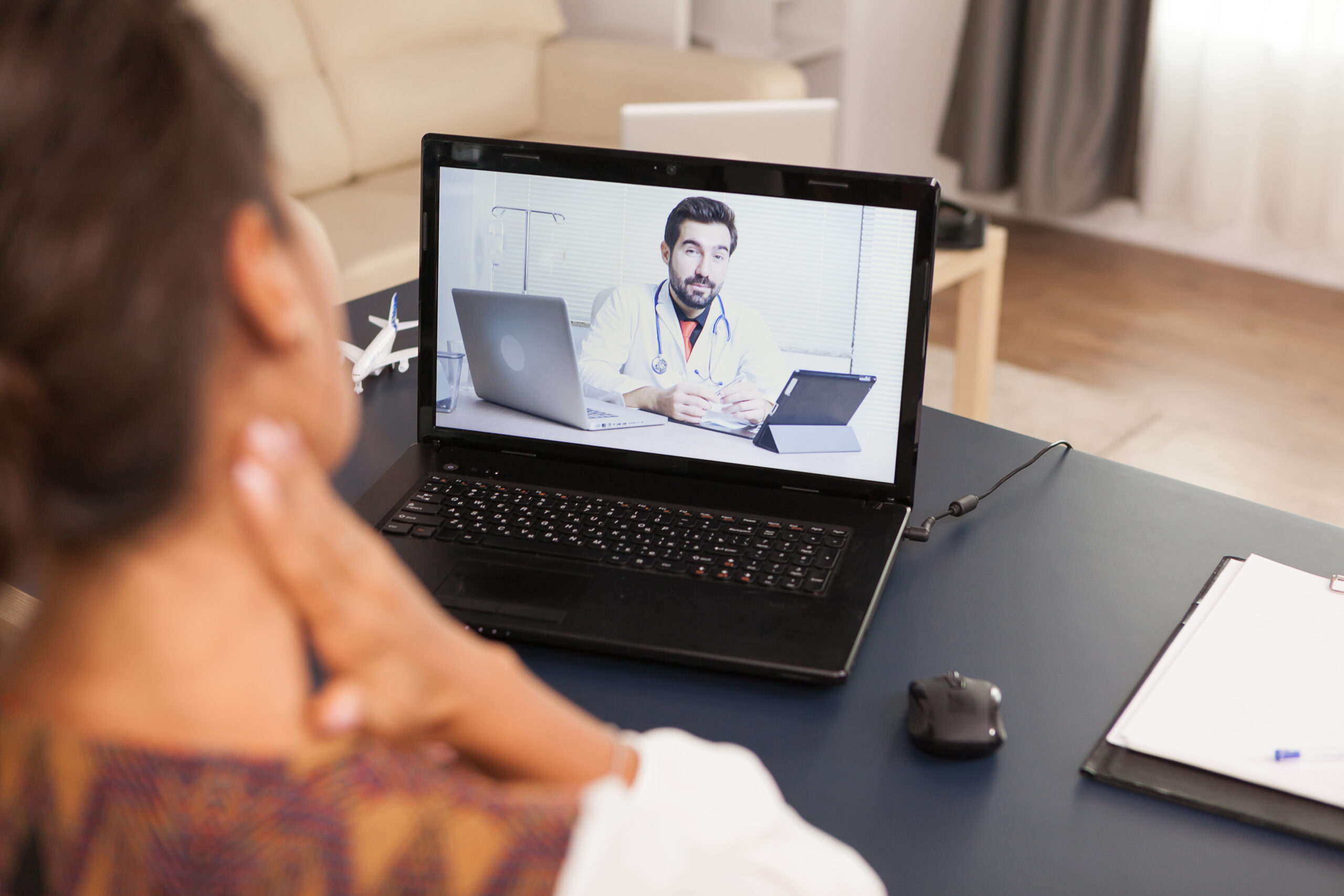 Female patient in a video call with doctor talking, single trip travel insurance, single trip insurance